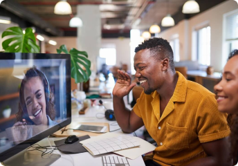 two people sat in front of a screen having a hybrid work meeting